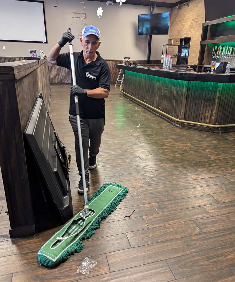 Cronos team member caring for a restaurant dining-area floor